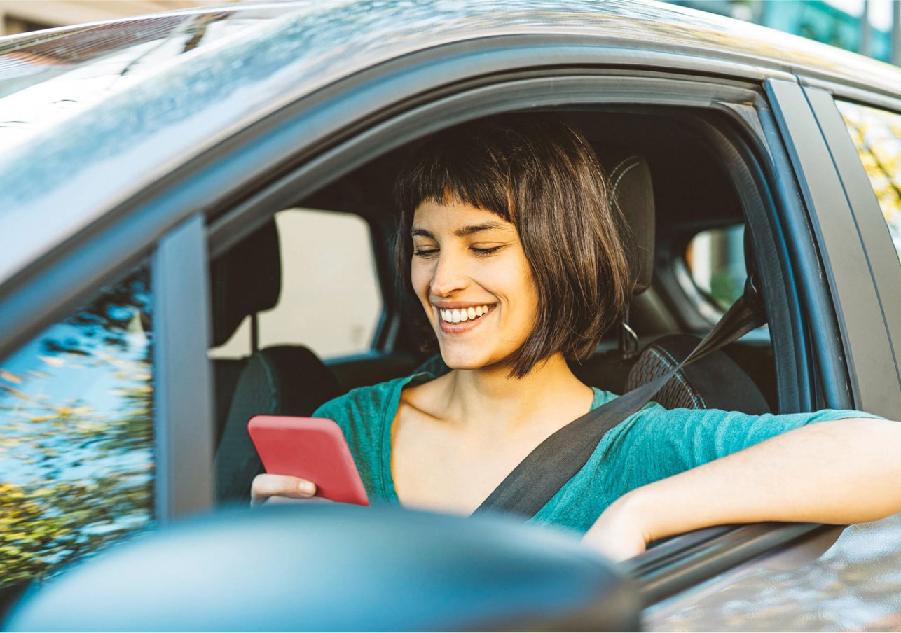 Woman on phone in stationary car 